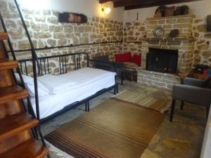 a room with a bunk bed and a fireplace at Estia Tsialiki in Kato Pedina