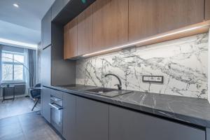 a kitchen with a sink and a counter top at Homly S22 in Riga