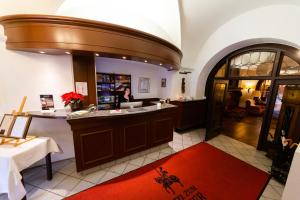 a woman standing at a counter in a room at Hotel zum Ritter St. Georg in Heidelberg