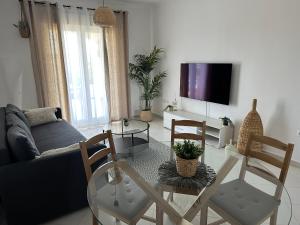 a living room with a couch and a table and chairs at La Giralda in Denia