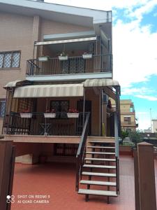 a building with a staircase and a balcony at La Posada Roma in Rome