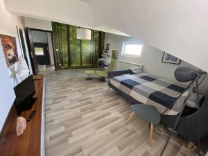 a bedroom with a bed and a living room at Vila Sunset Jugovo in Udovice