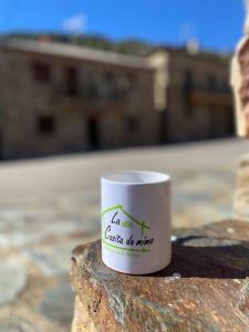 a coffee mug sitting on top of a rock at La Casita de mimo. 