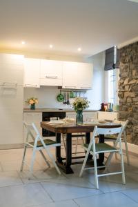 a kitchen with a wooden table and two chairs at The Secret Garden in Como