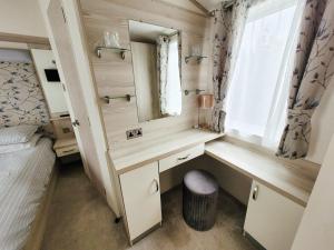 a bathroom with a sink and a mirror in a room at Meadow Lodge in South Cerney