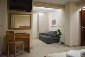 a living room with a couch and a chair at ACROPOLIS GATE in Athens