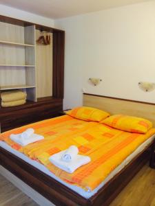a bedroom with a large bed with towels on it at Apartmaji Kranjska Gora in Kranjska Gora