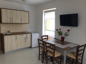 a kitchen and dining room with a table and chairs at Apartmaji Kranjska Gora in Kranjska Gora
