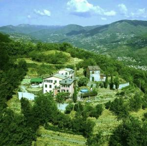 an aerial view of a house on a hill at @gatetothewild in Coreglia Ligure