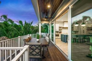 a deck with a table and chairs on a house at Beach Views in Bailey Hall