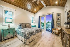 a bedroom with a bed and a large window at Beach Views in Bailey Hall +54 photos