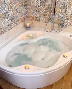 a bath tub filled with water with candles in it at Il Borgo in Subiaco