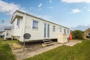 a white trailer is parked in a yard at 8 Berth Caravan For Hire At California Cliffs Holiday Park In Norfolk Ref 50046l in Great Yarmouth