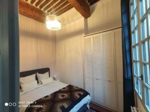 a bedroom with a bed and a large window at Appart'n Ville in Aix-en-Provence