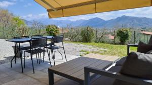 a table and chairs on a patio with a view at Aria di Franciacorta in Corte Franca