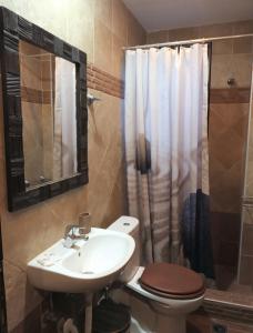 a bathroom with a sink and a toilet and a shower at Athina-Milina in Milína