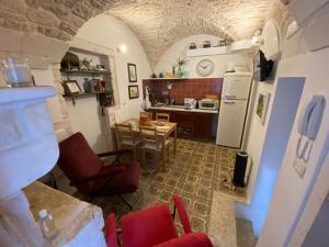 a kitchen with a table and chairs and a refrigerator at Residenza Le Tre Volte - colazione inclusa con TicketBar in Martina Franca