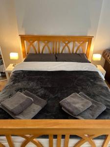 a bedroom with a bed with two pillows on it at 1 bedroom apartment in Shepherds Bush, London in London