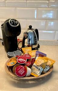 a basket of food sitting next to a coffee maker at 1 bedroom apartment in Shepherds Bush, London in London