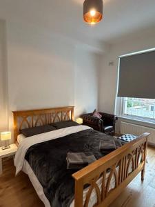 a bedroom with a large bed and a large window at 1 bedroom apartment in Shepherds Bush, London in London