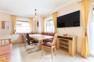 a dining room with a table and chairs at Pension Glockenstuhl in Finkenberg