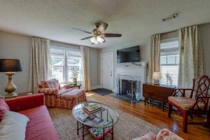 a living room with a couch and a fire place at Bama Bungalow in Tuscaloosa