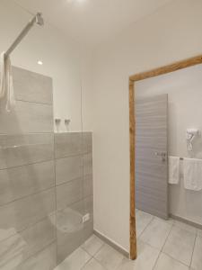 a bathroom with a shower and a glass door at Tenuta di Venere in Portovenere