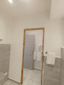 a bathroom with a mirror and a shower with towels at Tenuta di Venere in Portovenere