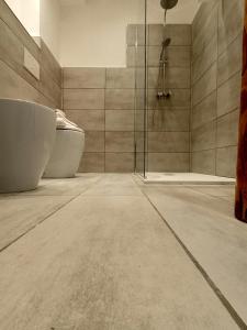 a bathroom with two tubs and a shower at Tenuta di Venere in Portovenere