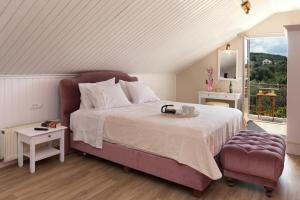 a bedroom with a large bed and a window at Magnolia Apartments in Fiskardo