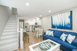 a living room with a blue couch and a kitchen at Island Time West in Siesta Key