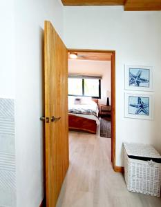 a door leading to a bedroom with a bed at Dragonfly Beach Retreat Beachfront Casitas-Adult Only in Punta Uva