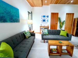 un soggiorno con divano e tavolo di Dragonfly Beach Retreat Beachfront Casitas-Adult Only a Punta Uva