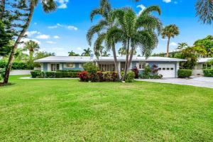 a house with palm trees and a yard at Blue Palm in Bailey Hall