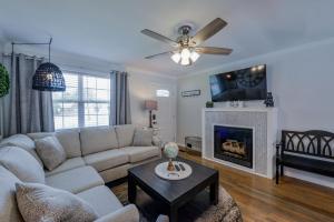 a living room with a couch and a fireplace at Bama Cottage in Tuscaloosa