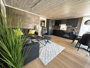 a living room with a couch and a table and chairs at Lovise Mountain Apartment in Stranda