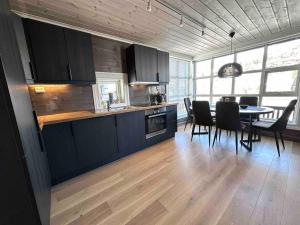 a kitchen and dining room with a table and chairs at Lovise Mountain Apartment in Stranda