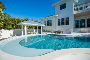 a swimming pool in front of a house at Beach Fanta Sea in Sarasota