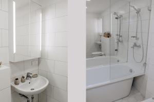 a white bathroom with a shower and a sink at Šventoji Elija in Palanga +20 photos