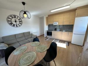 a living room with a wooden table and a kitchen at Best view from Pallars in Talarn