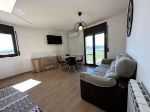 a living room with a couch and a table at Best view from Pallars in Talarn