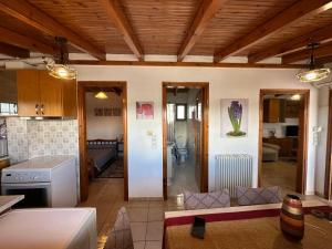 a kitchen and a living room with a couch at Bratis House 2 in Vartholomio