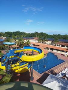 a pool with a water slide in a resort at JL Temporadas - Quarto Portobello Park Hotel in Porto Seguro