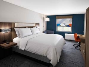 1 dormitorio con 1 cama blanca grande y escritorio en Holiday Inn Express and Suites - Nokomis - Sarasota South en Nokomis