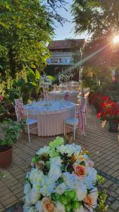 a table set up for a party with flowers at Kesten Futog in Futog