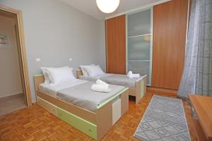 a room with two beds and a closet at Mesaria House Syros in Ermoupoli