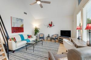 a living room with a couch and a tv at Redbird Retreat On Lake Travis in Marble Falls