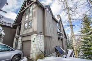 a house with a car parked in front of it at Pinnacle Ridge 05 - Ski In Ski Out, Private Hot Tub, Gas Fireplace in Whistler