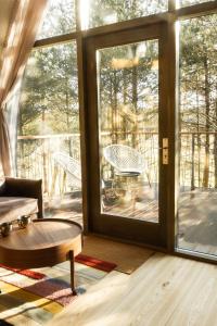 a living room with a large sliding glass door at Jungle SPA bungalows in Žocenes Ciems