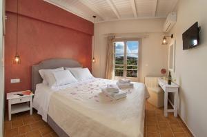 een slaapkamer met een groot bed met een rode muur bij Magnolia Apartments in Fiskardho